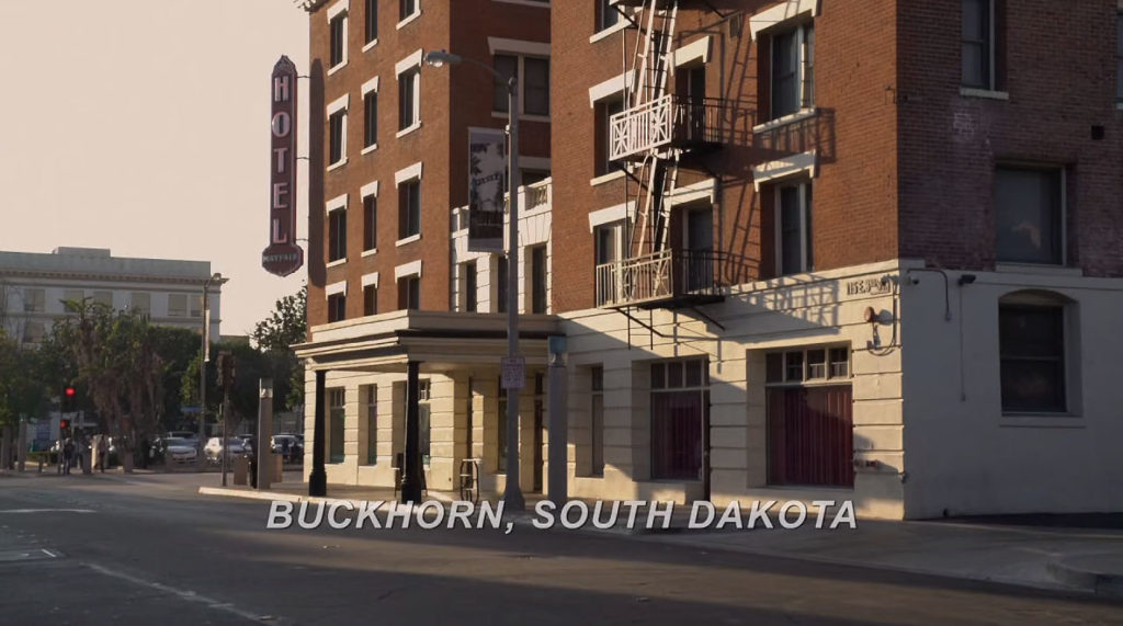 Exterior of hotel with words Buckhorn, South Dakota on screen