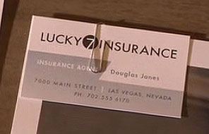 Close up of Douglas Jones' business card from Lucky 7 Insurance