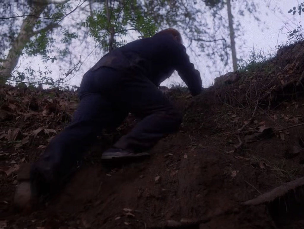 Major Briggs climbing out of a ravine in Episode 2021