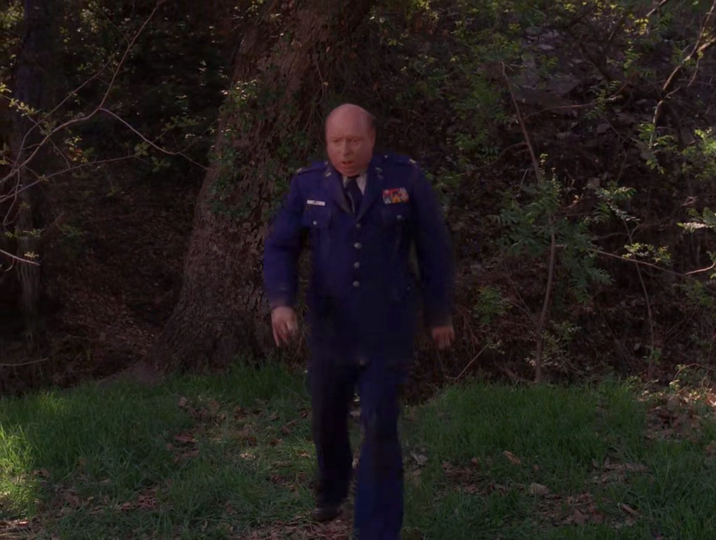 Major Briggs walking out of the woods in Episode 2021.