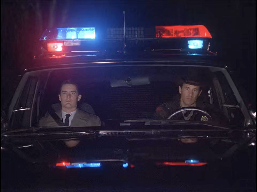Cooper and Truman in the Police Vehicle