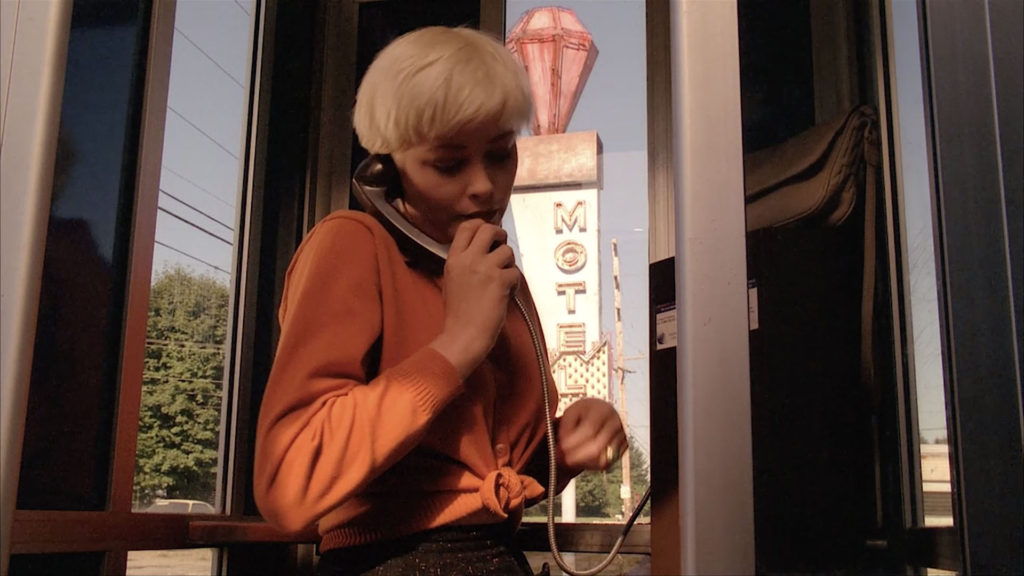 Teresa on the Phone in a phone booth