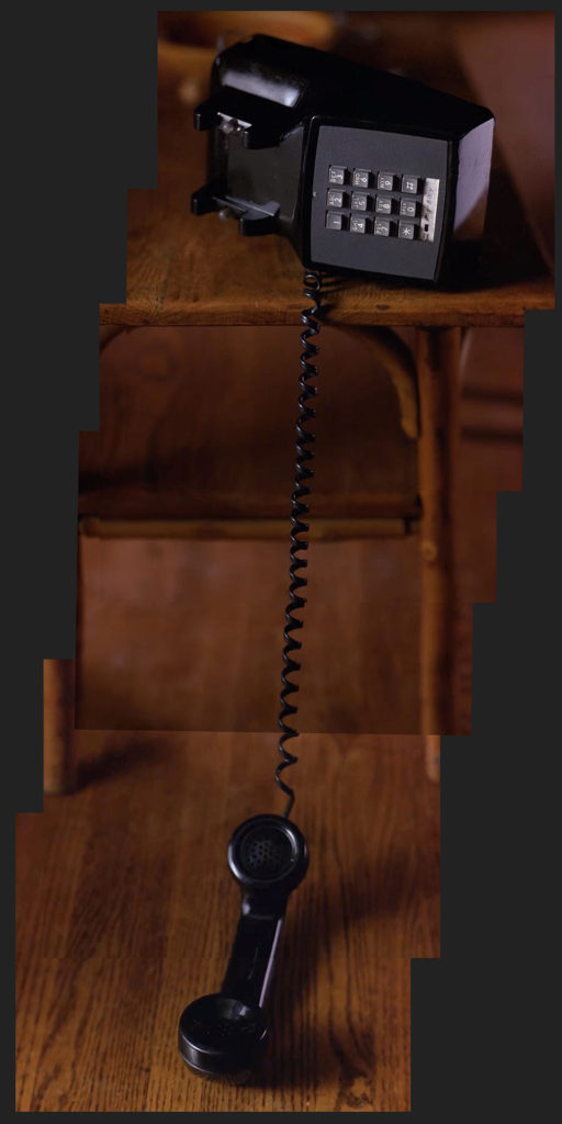 Black Phone hanging off an end table