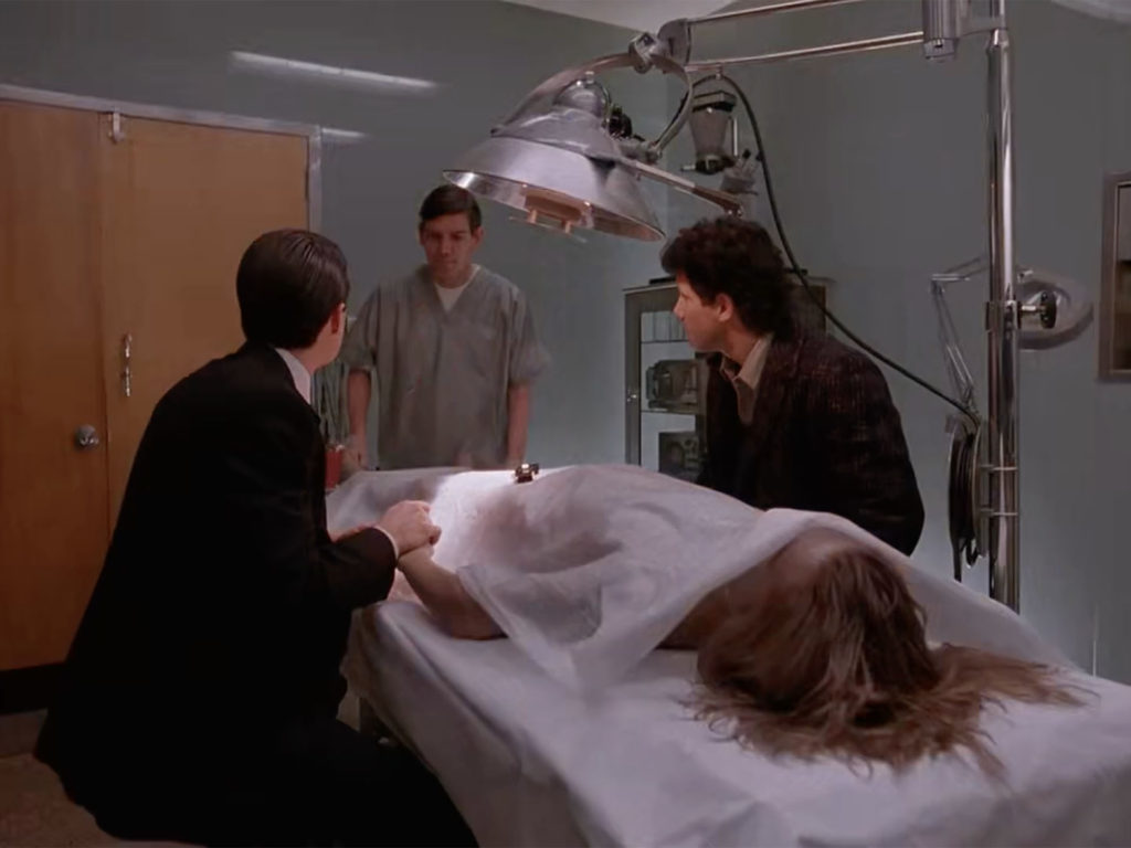 Jim the attendant speaking with Agent Cooper and Sheriff Truman while Laura Palmer lays on the gurney.