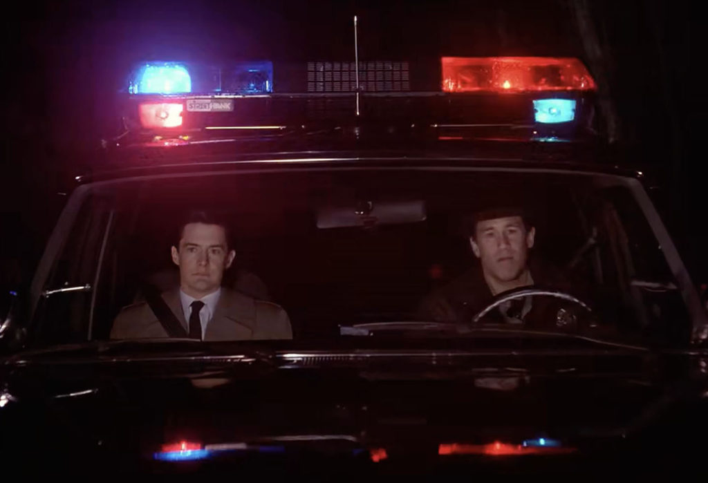 Cooper and Truman in the Sheriff's Vehicle