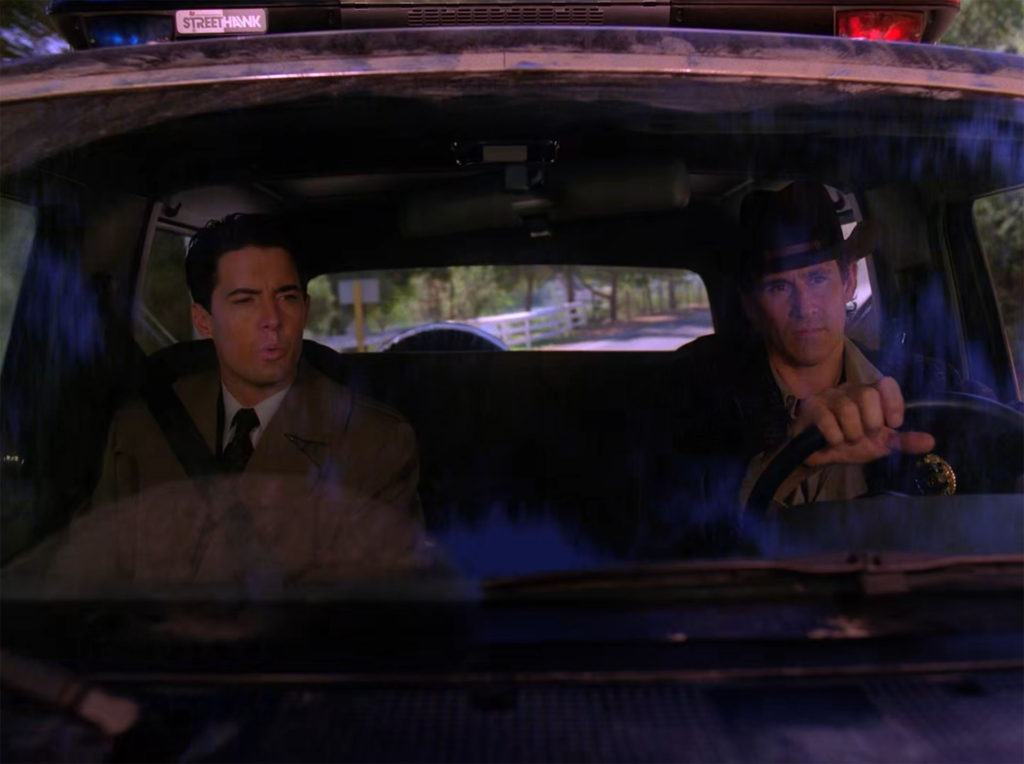 Agent Cooper and Sheriff Truman inside the Ford Bronco